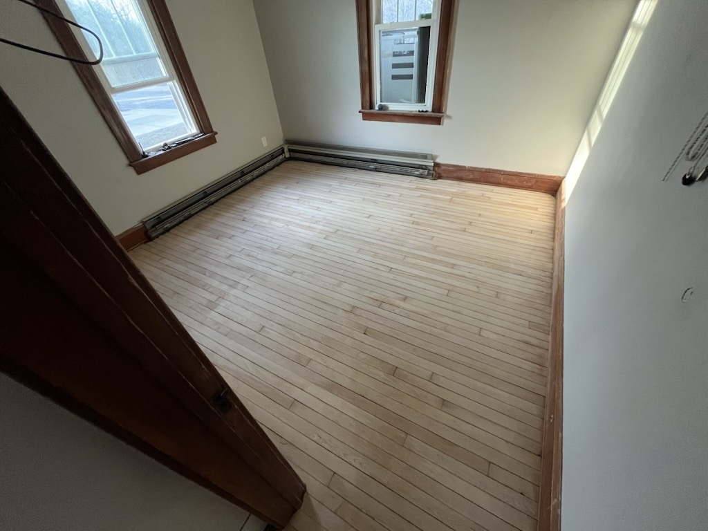 Beautifully restored hardwood floor after refinishing with rich natural finish
